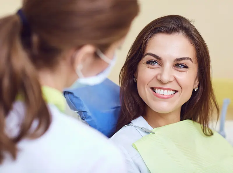 A patient talking with a Smile Makers dentist during an appointment